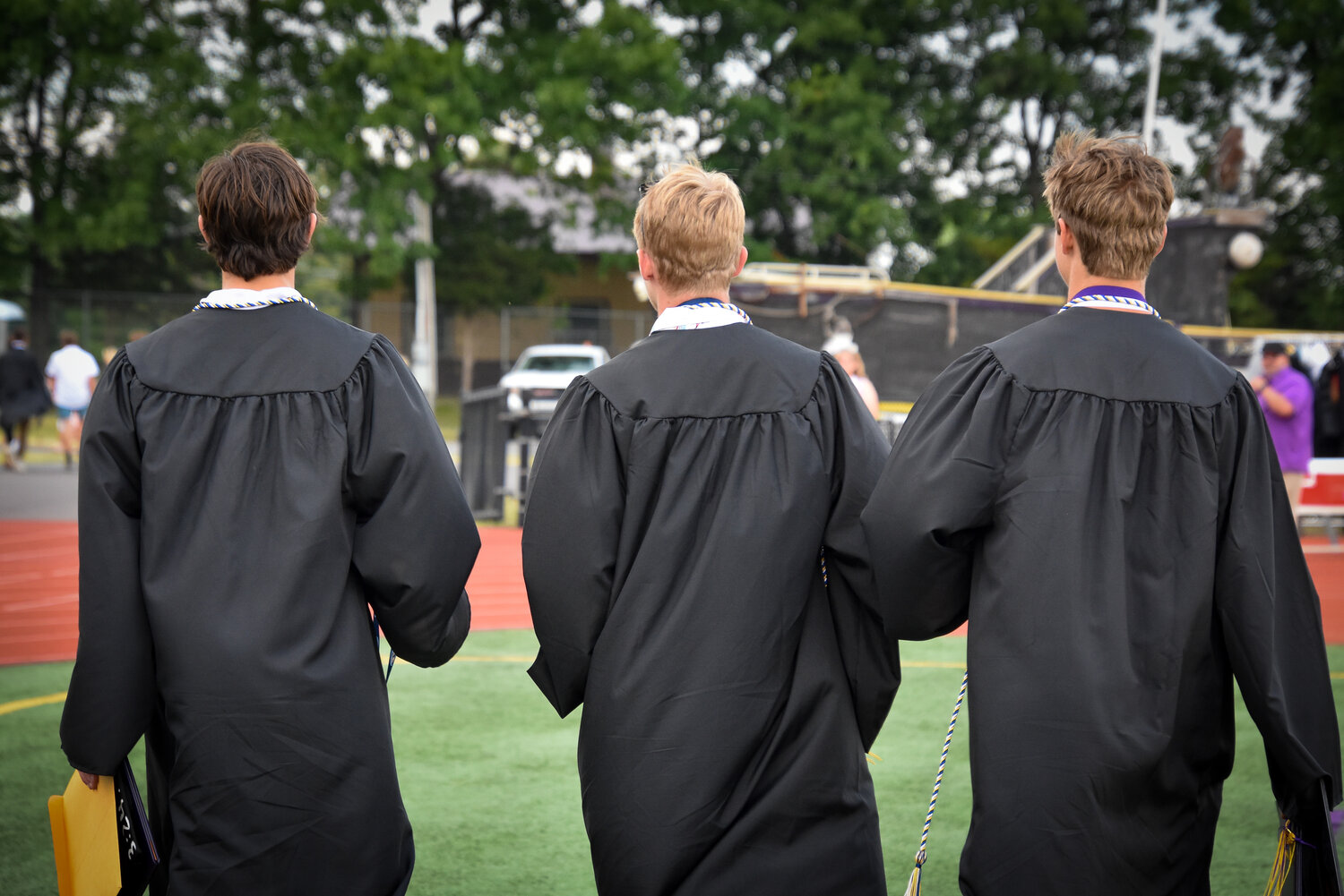 That’s a wrap. Three Palisades High School seniors head depart the Walter T. Rohrer Stadium on June 2 at the end of their graduation ceremony.