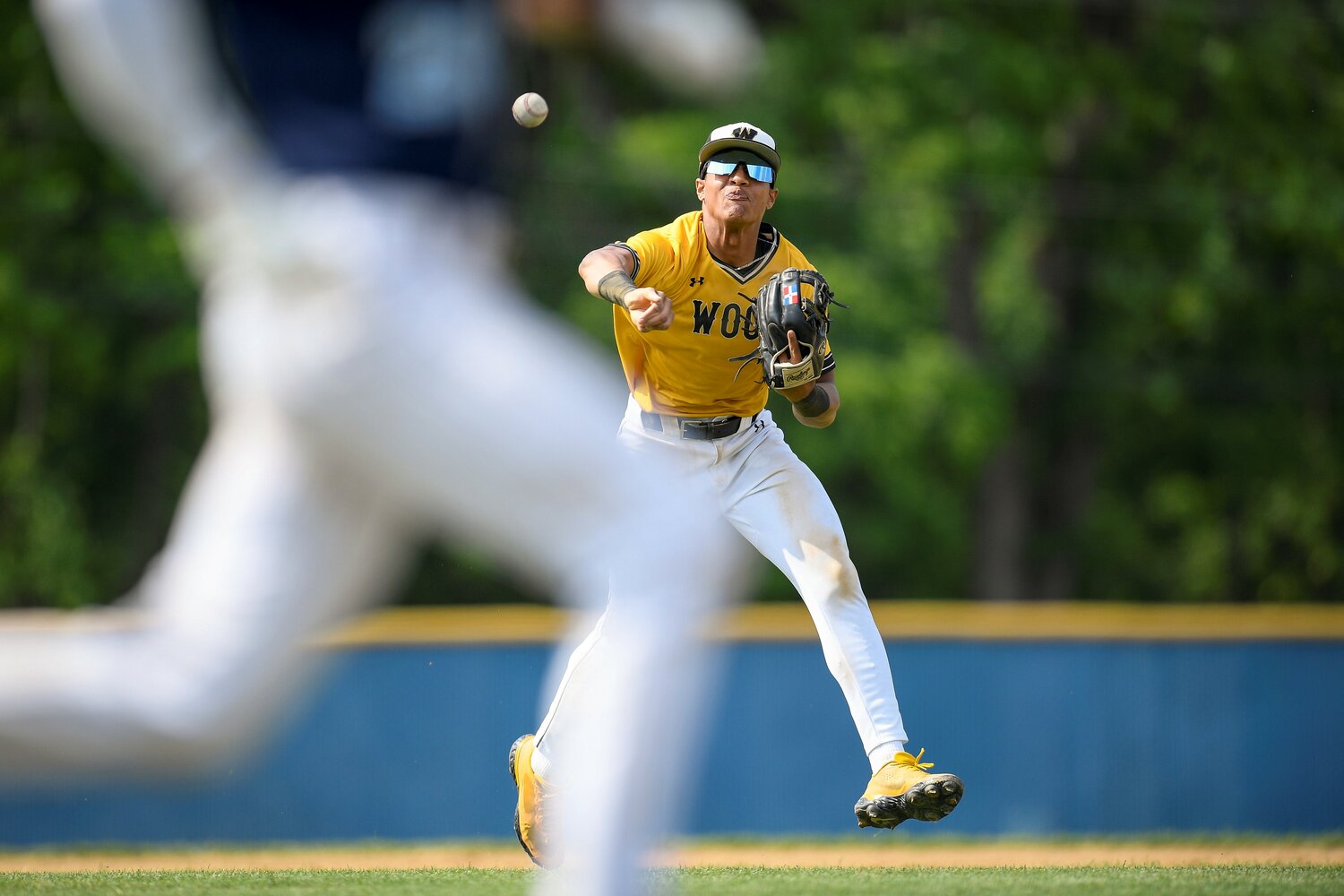 Wood third baseman Dariel Tiburcio tries to throw out a Dallas player after fielding a short grounder.