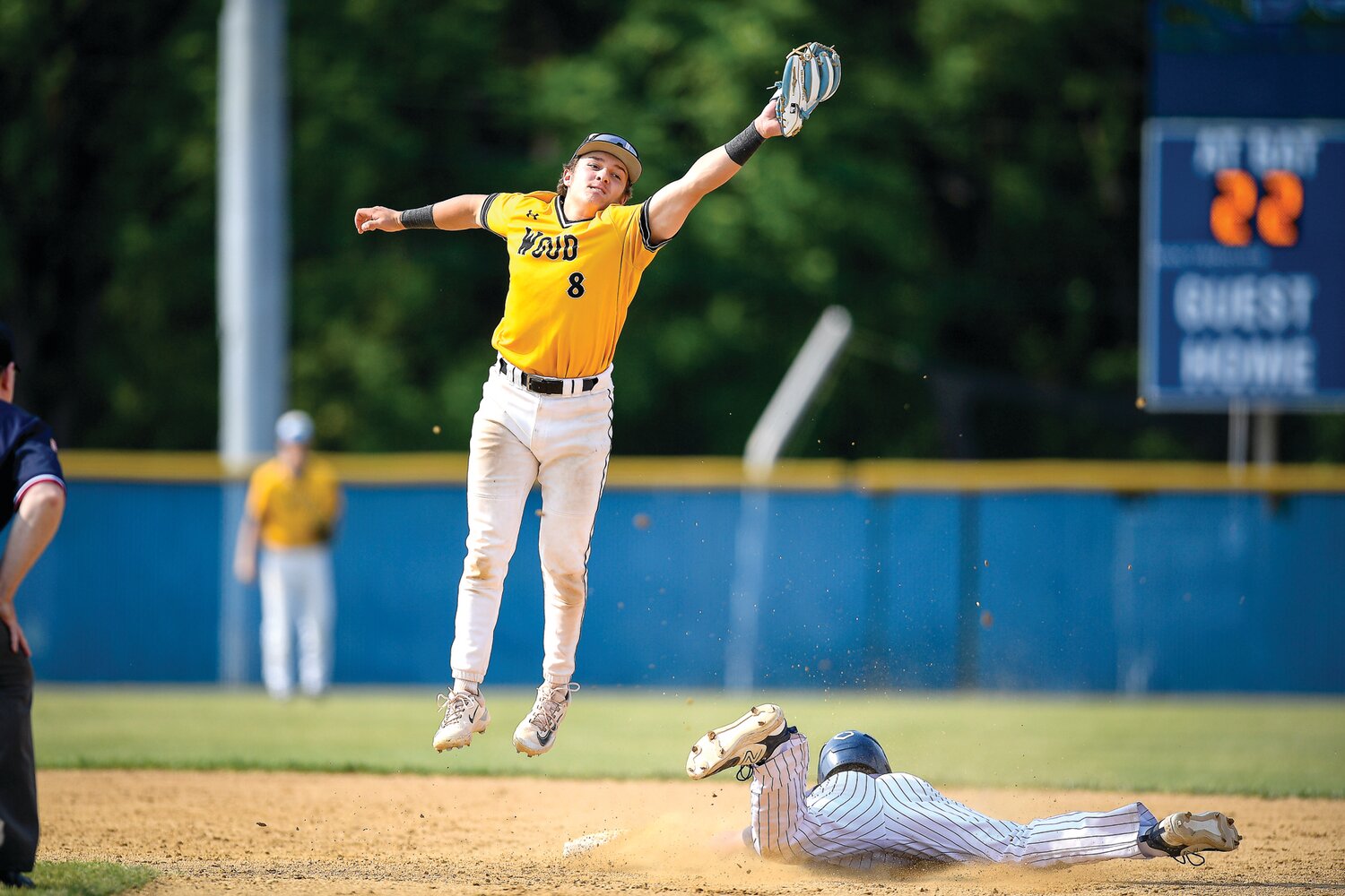 Archbishop Wood shortstop Patrick Gozdan leaps to catch a throw from catcher Logan Madison as Dallas’ Kaden Coyne steals second base.