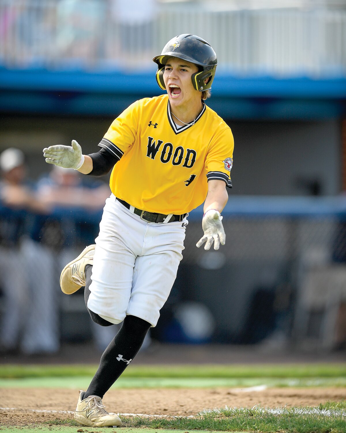 Archbishop Wood’s JP DiGuiseppe shouts to the dugout on his way to first base.