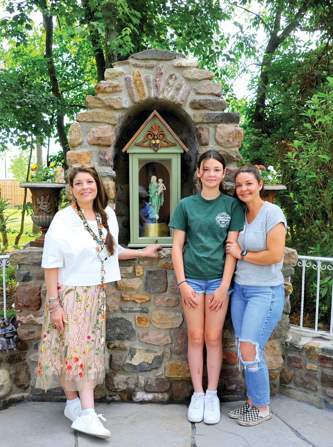At the Zegels’ “Avocation Acre,” a community vegetable garden with barn, apiary and chapel, are Melissa Palmer, Amelia Tracy and Jackie Chapman.