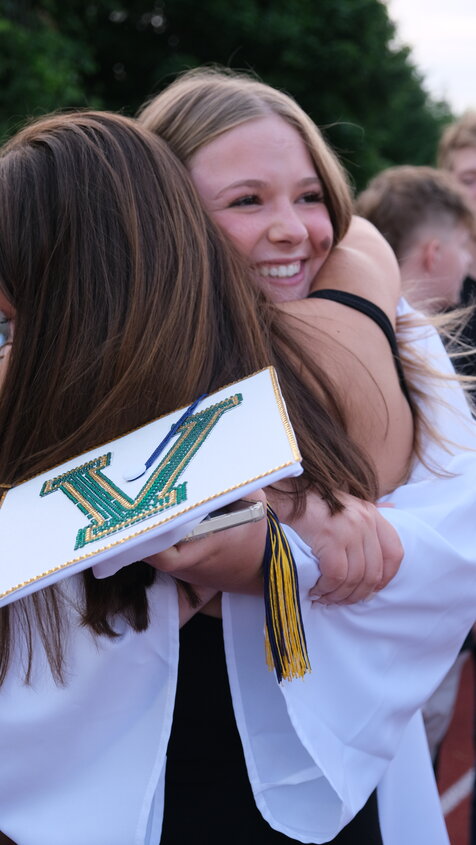 Margaux Grossman gives a wide smile and a big hug to a classmate at the end of the June 13 New Hope-Solebury graduation ceremony.