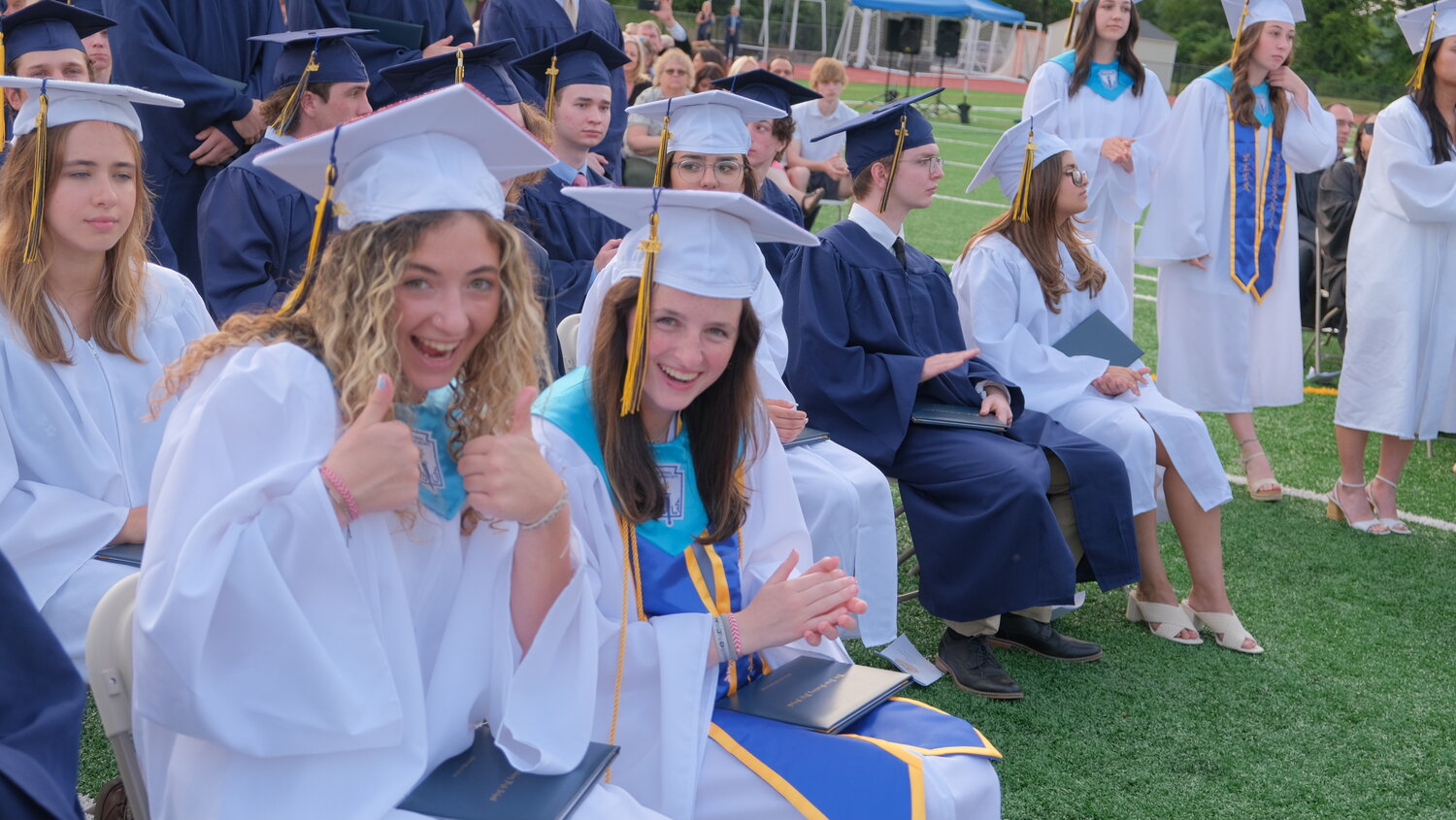 New Hope-Solebury High School Class Officer Sophia Cozza and Class President Abby Prosser are all smiles at the start of the June 13 graduation ceremony.