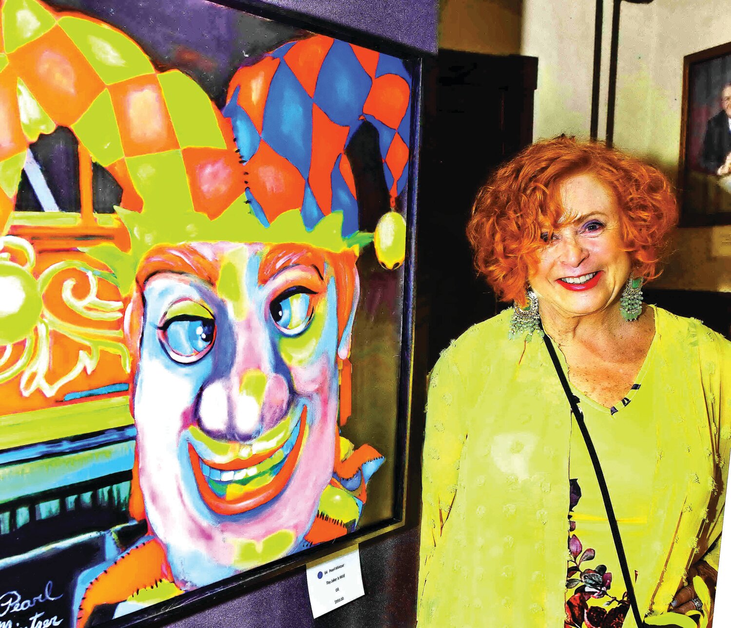 Pearl Mintzer, stands next to her oil painting, “The Joker is Wild.”