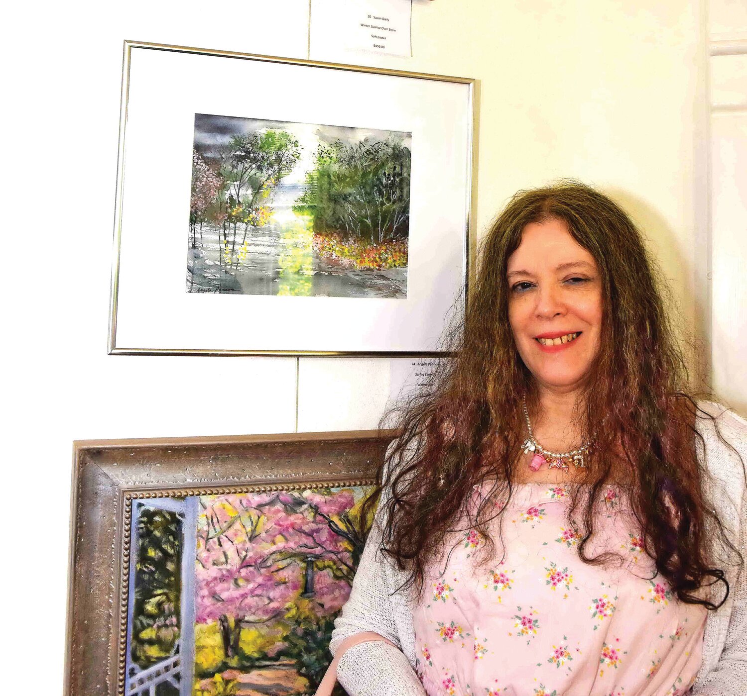 Angela Pannone stands next to her watercolor, “Spring Evening.”