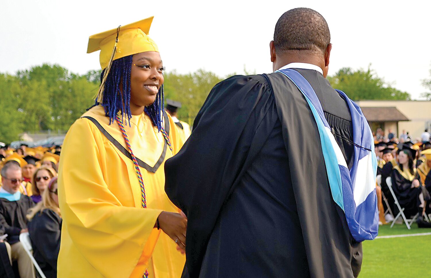 Central Bucks High School West graduate Naomi Watson shakes school principal Lyndell Davis’ hand after accepting her diploma at commencement.