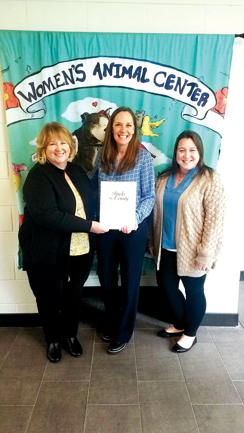 Mandy Mundy, executive director of the Bucks County Foundation, center, presents a grant award to Cathy Malkemes, Women’s Animal Center’s CEO, left, and Katie Ottaggio, director of community programs.