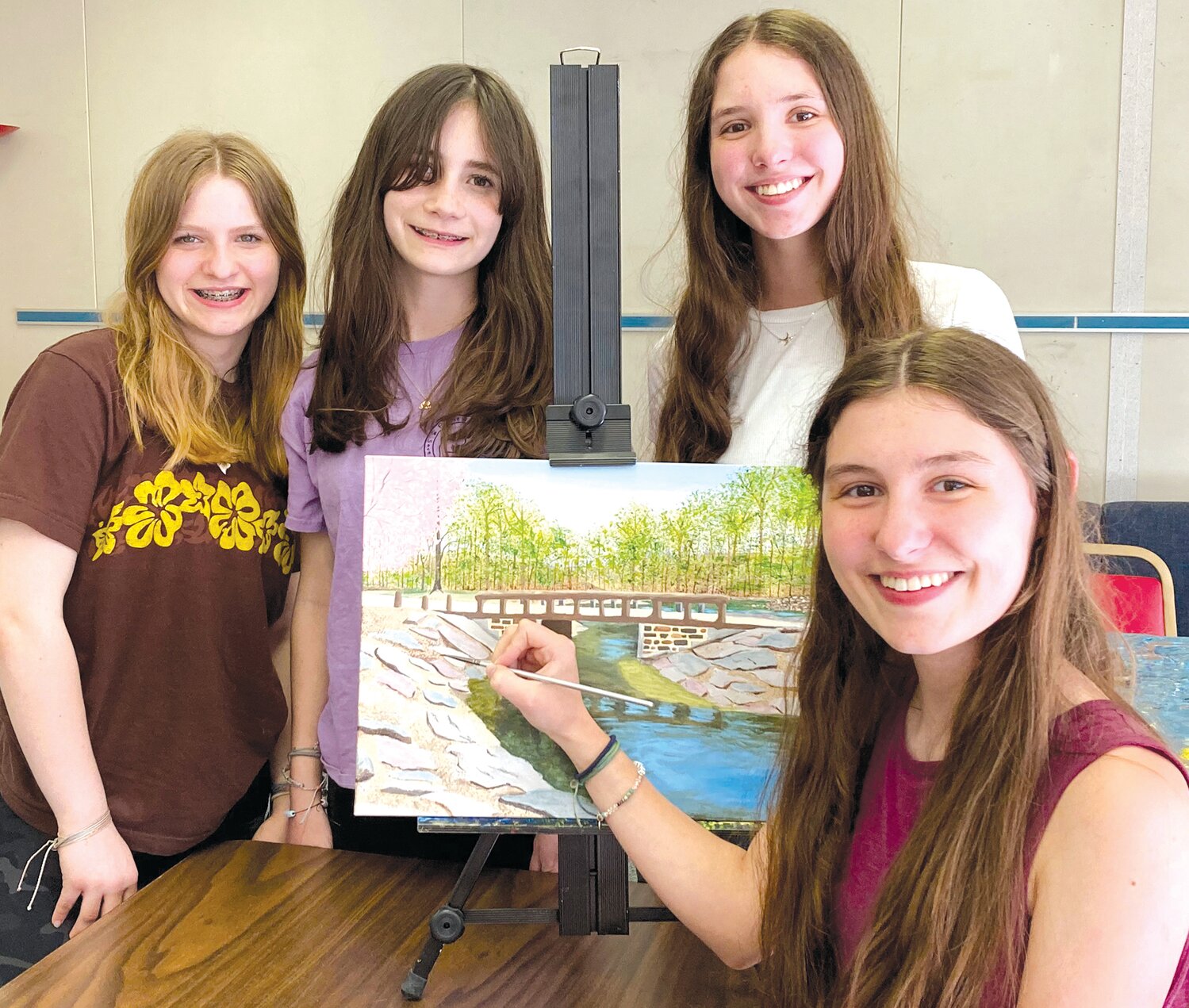 Victoria Cirillo, joined by Evangeline McGarry, Anna Sherwin, and Allison Cirillo, adds the finishing touches to “Springtime at Tyler Park.”