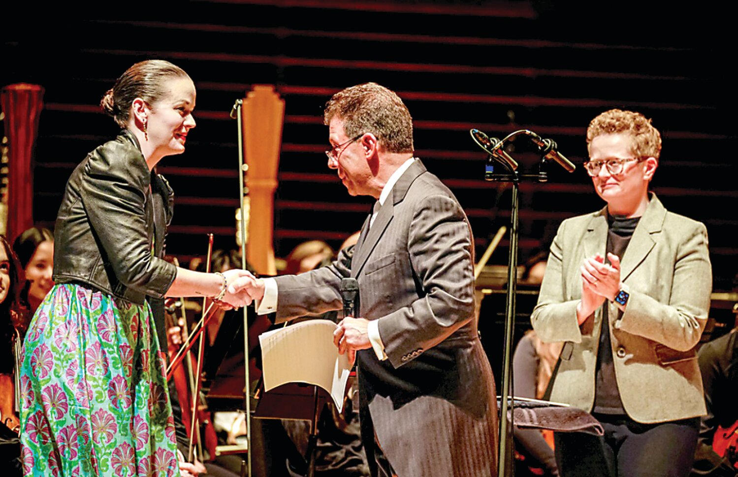 Noelle Casella Grand is honored in Verizon Hall at the Kimmel Center by Maestro Louis Scaglione and  Philadelphia Youth Orchestra Music Institute COO Colleen Hood.