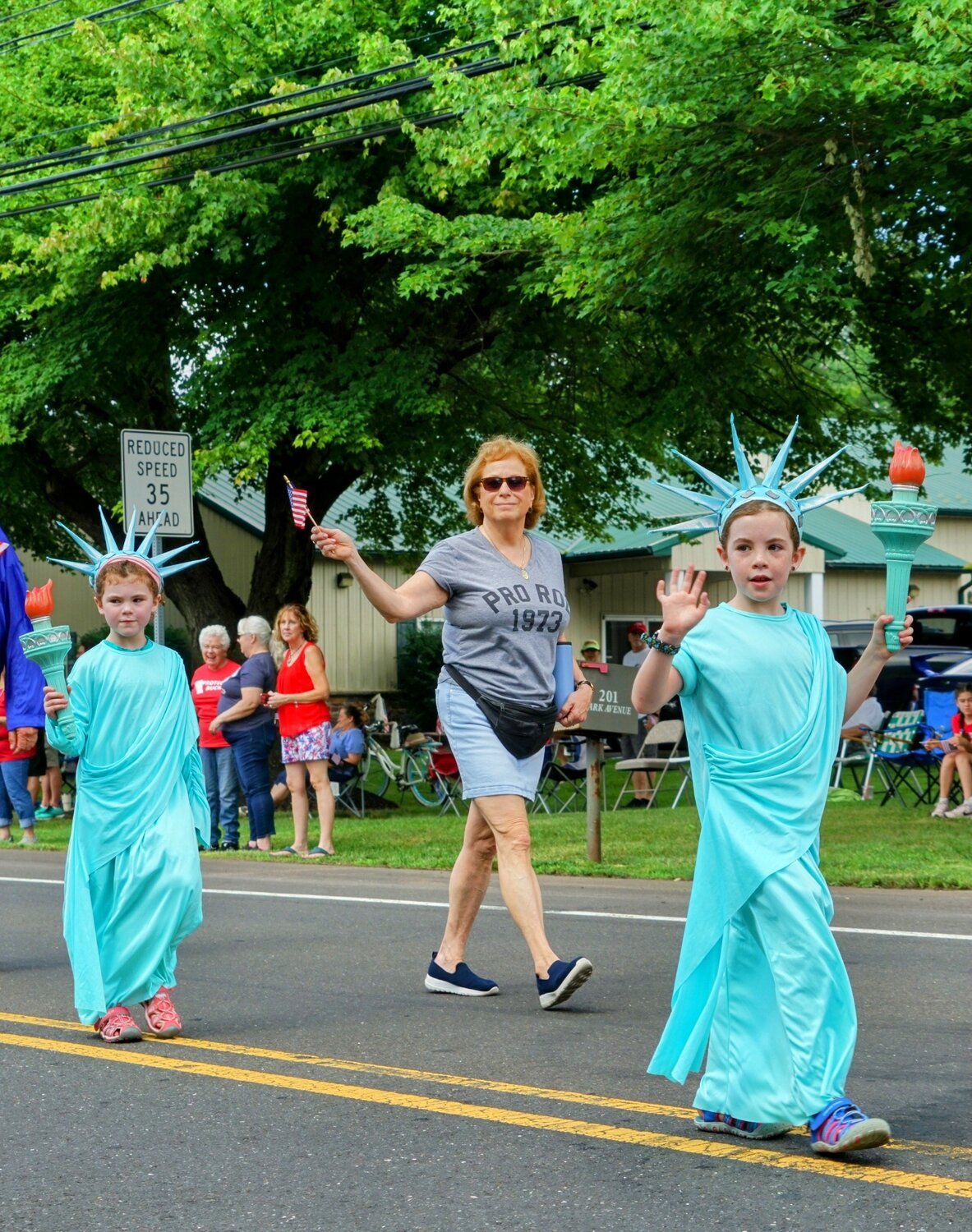 Young Lady Liberties march in the Tri-Municipal July 4 Parade Tuesday morning.