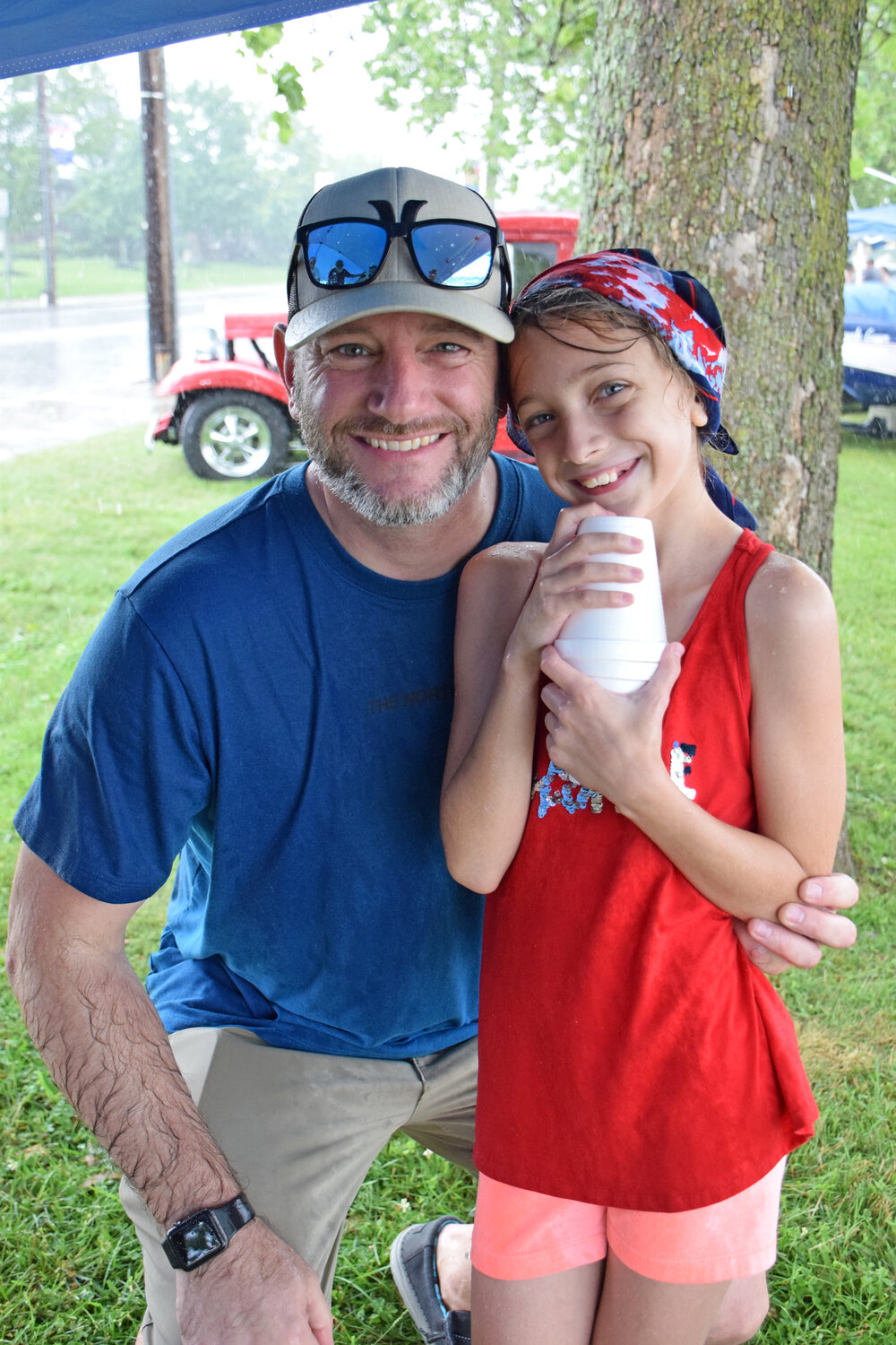 Josh Story, of Quakertown, tries to stay dry with his daughter, Alyssa, during Quakertown’s Fourth of July celebration at Memorial Park.