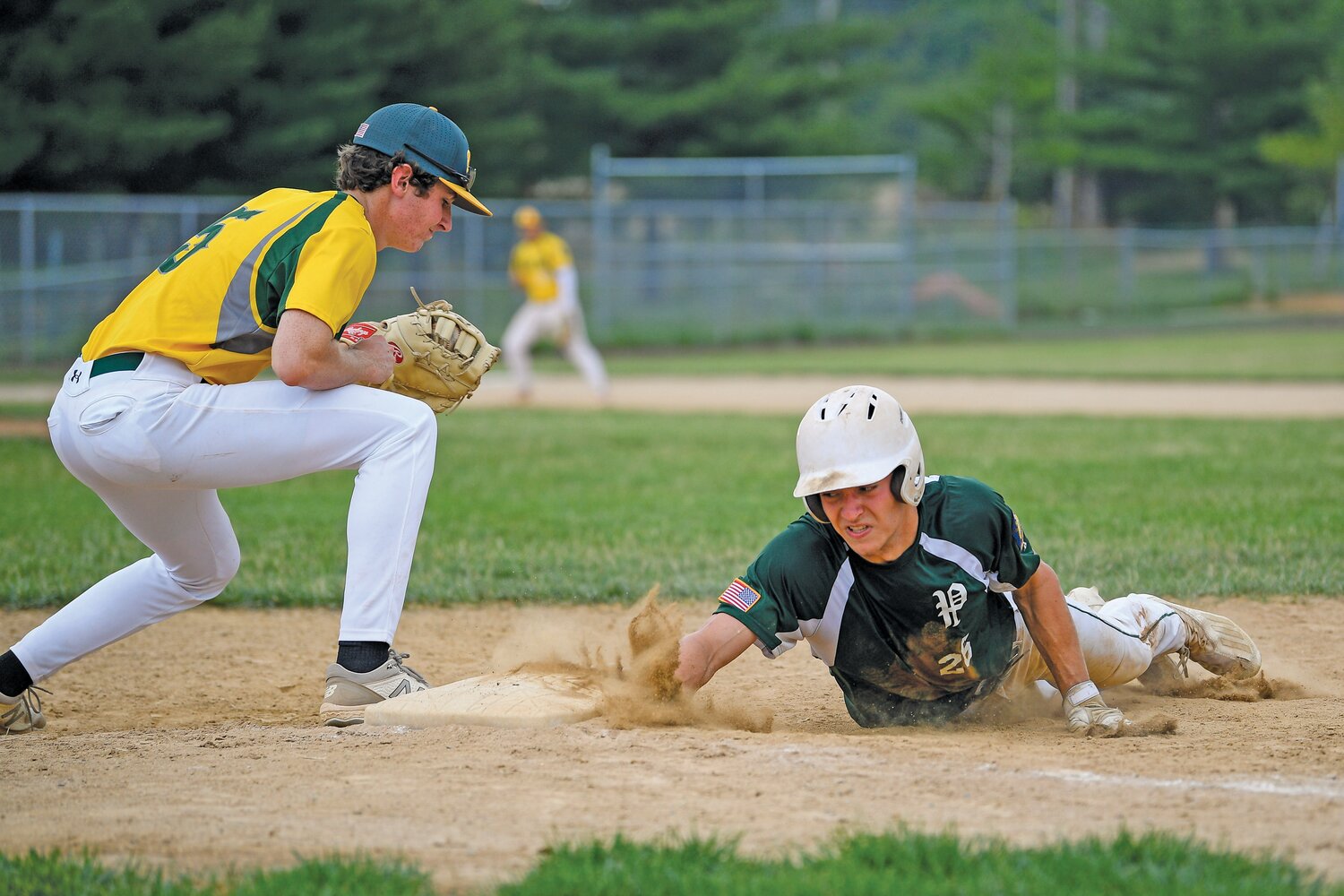 Pennridge’s Will Slamm dives back to first during a second inning pickoff attempt in Game 1 against Nor-Gwyn.