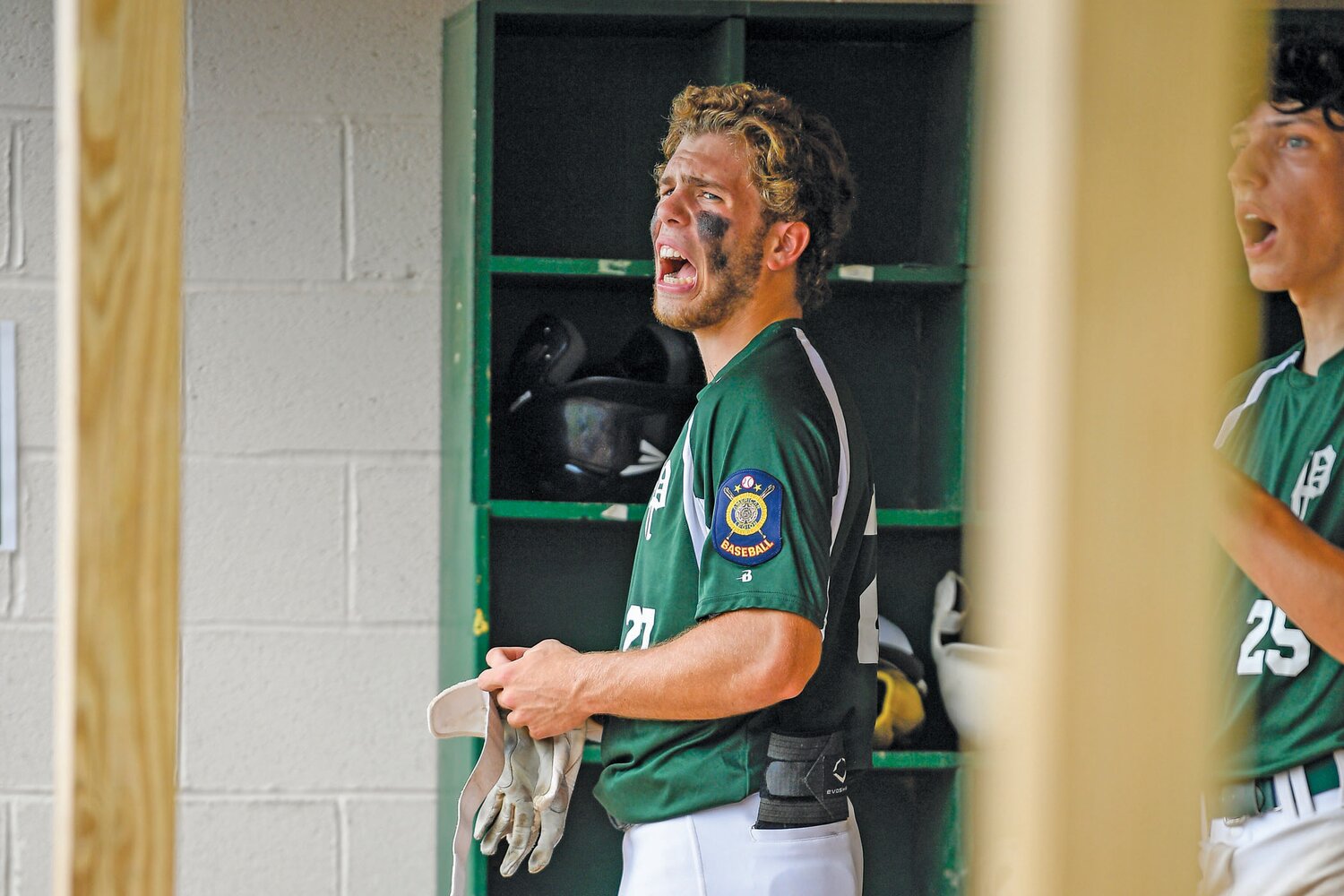 Pennridge’s Nate Lapp shouts from the dugout during the seven-run outburst in the fourth inning of Game 1.