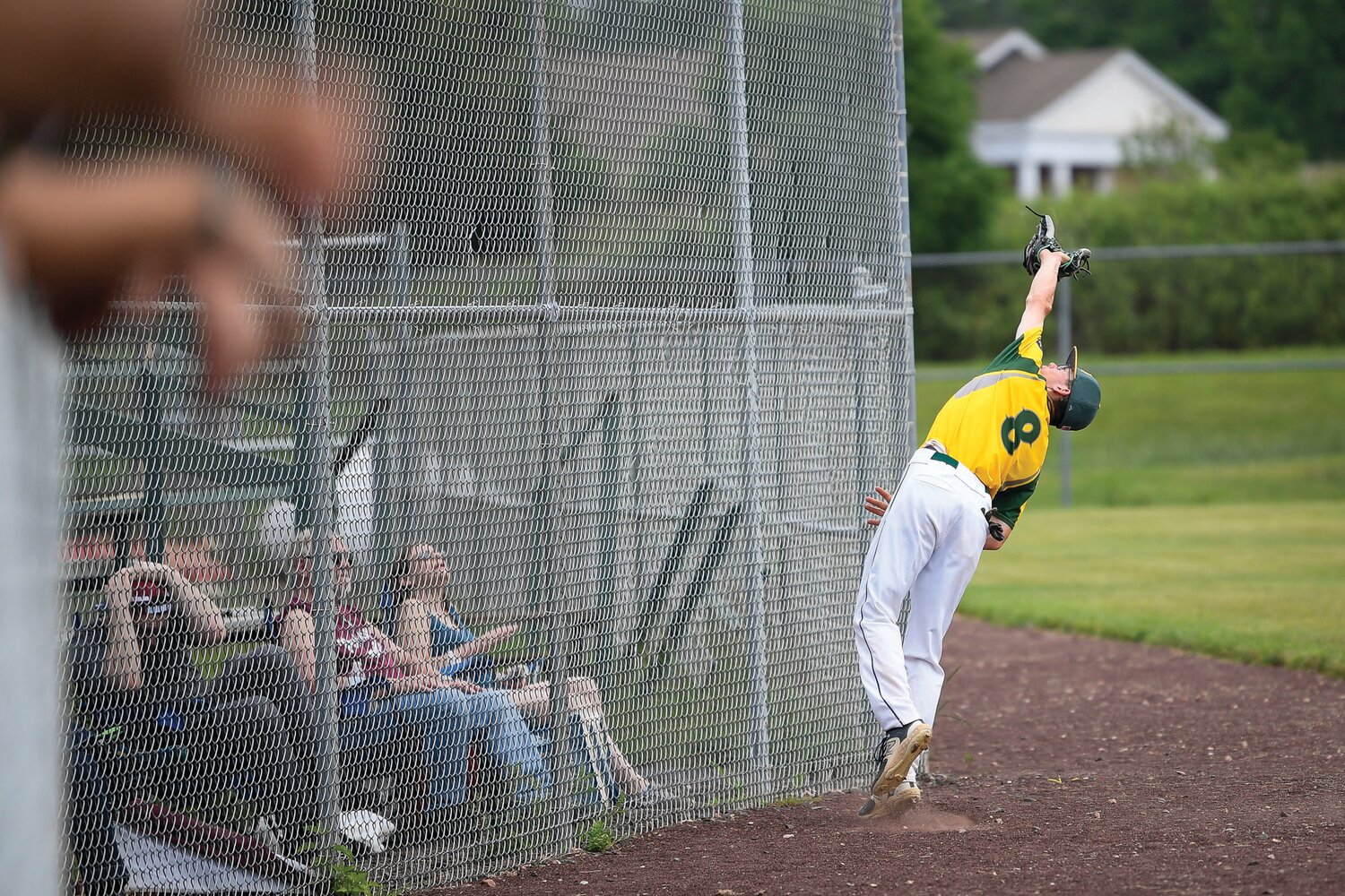 Nor-Gwyn’s Jeremiah Criger makes a nice grab on a foul ball as fans take cover during the fifth inning of Game 1 Sunday.