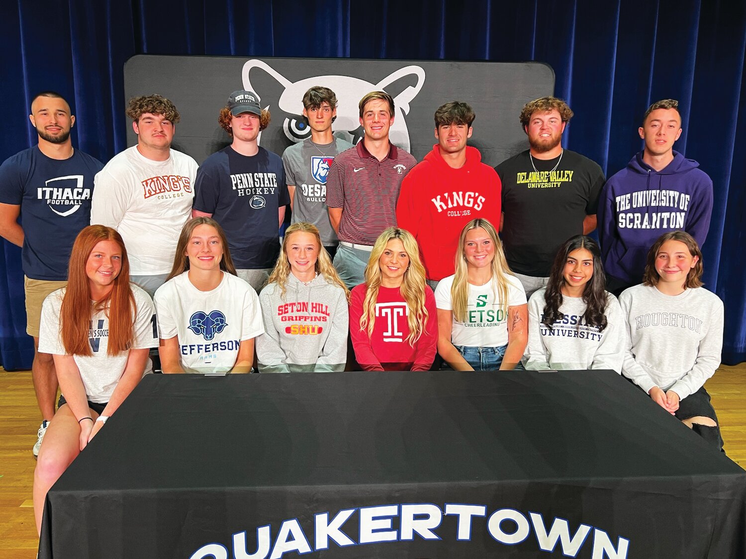 Quakertown seniors were recognized on May 23 for their commitment to compete in collegiate sports.  From left are: front row, Maddie Kalinowski, Carolyn Sipprell, Mya Hibsman, Olivia Litvinchuk, Sydney Bishop, Kayra DeVries, Risa Palmer-Kusiak; back row, John Eatherton, Nick Laudenberger, Connor Ellmore, Chris Parrillo, Tyler Wilkin, Michael Richino, Vinny Pellegrini and William Dickson.