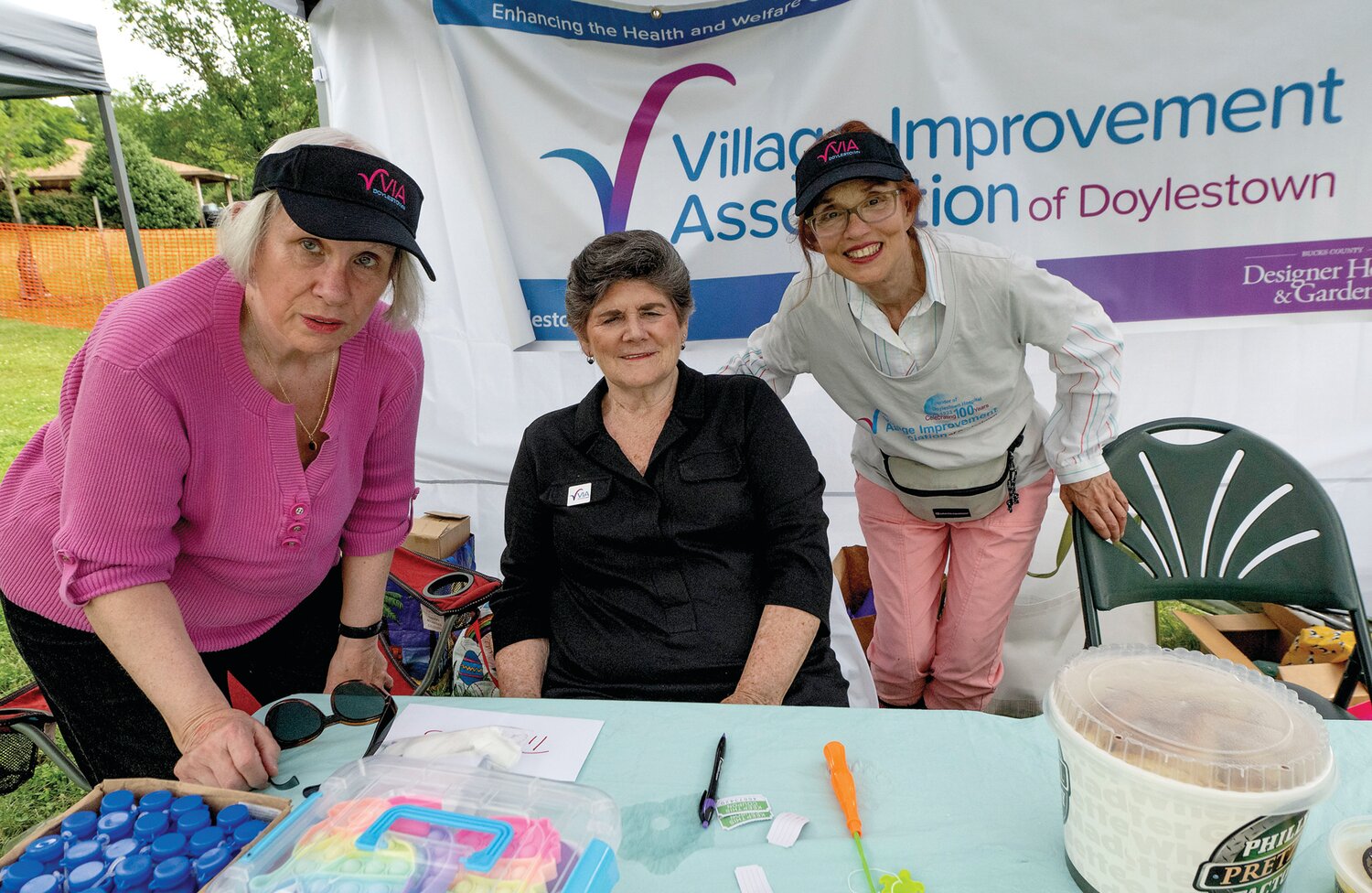 Members of the Village Improvement Association greet guests arriving at the Village Fair June 24.
