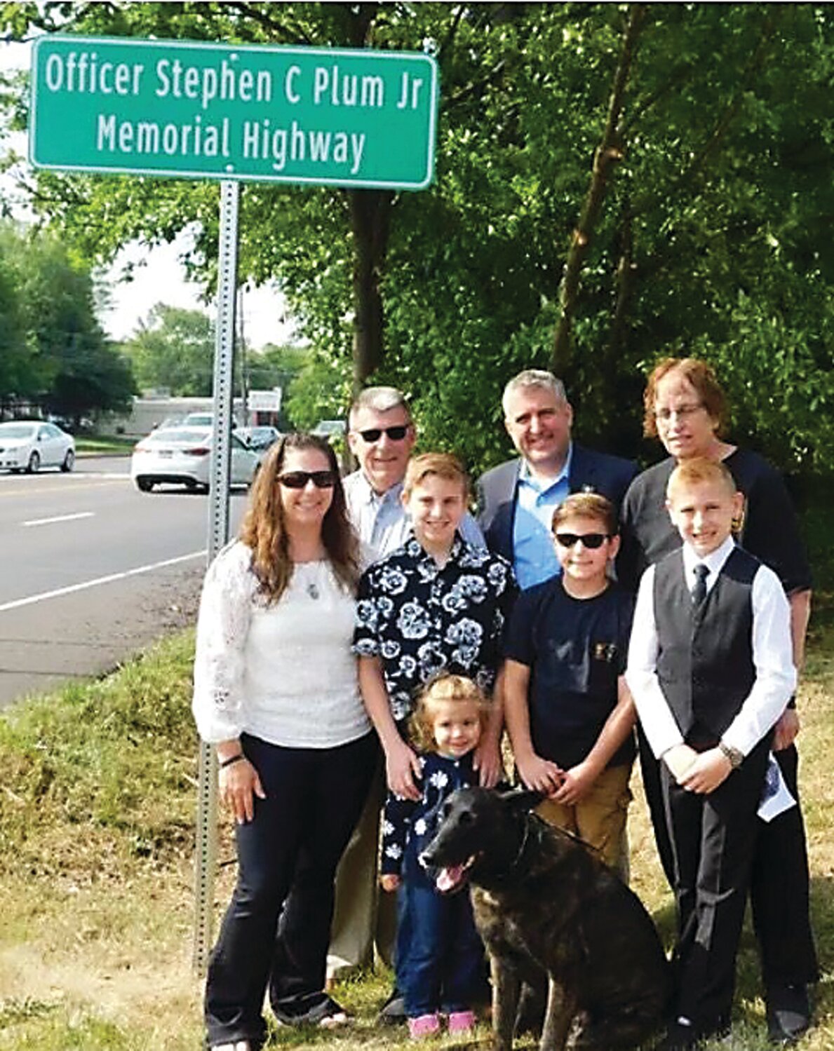 Warrington Township  officials recently renamed a section of Route 611 in honor of Officer Stephen C. Plum Jr..
From left, rear, Stephen Plum Sr., state Sen. Frank A. Farry, Leslie Watt, Nancy Plum and four of the couples’ five children — Aiden, Emmett, Wyatt and Francesca. Andrew was unable to attend. Murphy was Officer Plum’s K-9 officer.