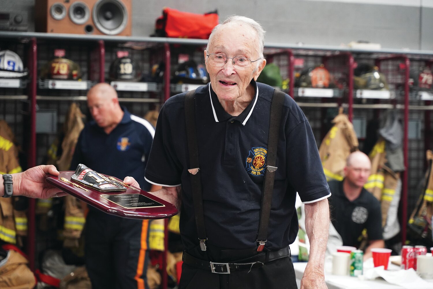 Life member of the Doylestown Fire Co. #1 Clayton Long accepts a plaque, given in appreciation for his 70  years of service to the company at its June 7 “Old Timers Night.”