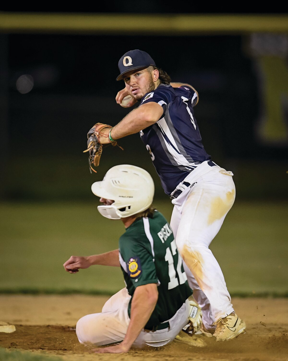 Quakertown shortstop Ty Everitt tries to turn a double play in the bottom of the fourth as Pennridge’s Robbie Pliszka slides in close.