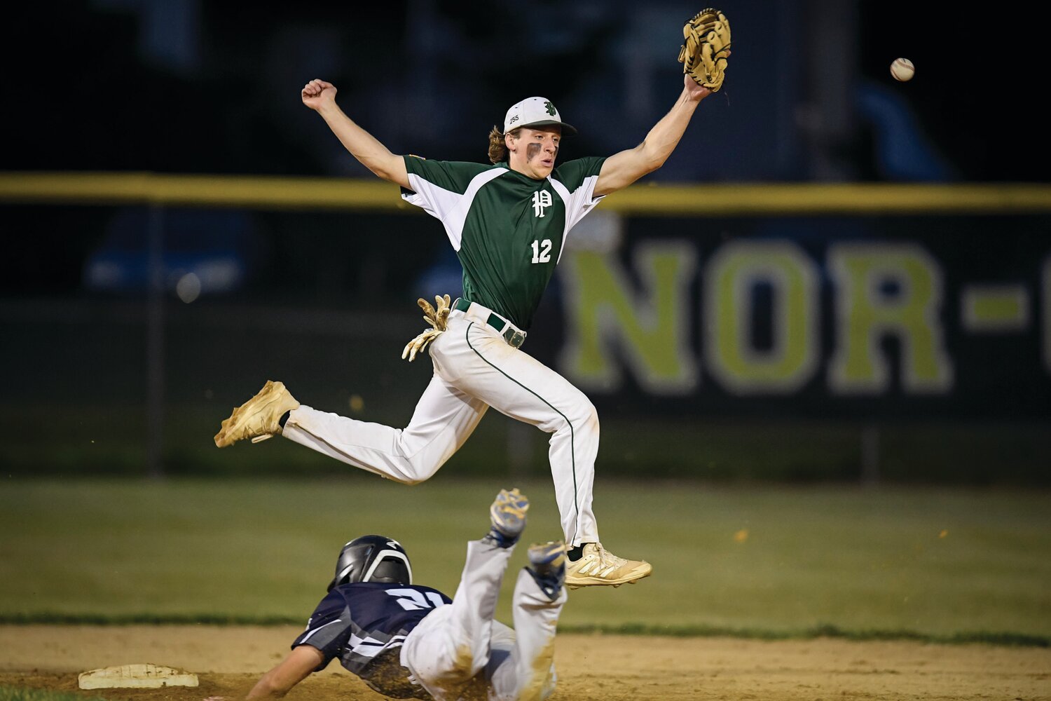 Pennridge shortstop Robbie Pliszka leaps over the slide of Quakertown’s Peyton Myers during a steal attempt in the top of the fourth inning.