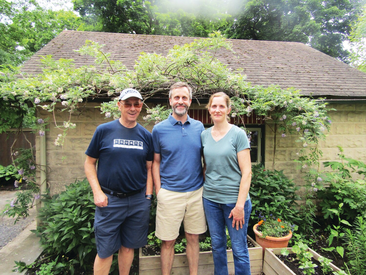 Garden host Kevin Baker with garden hosts Kristin and Mike Winters in the Winters garden.