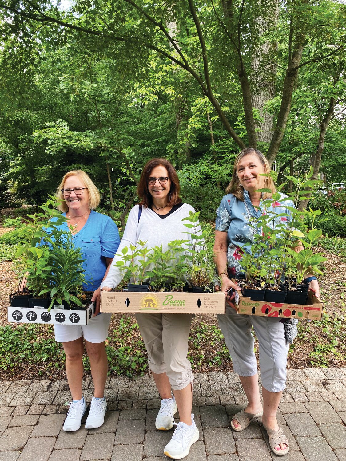 Jean Talerico, Gena Maresca and Laura Zuby purchase native plants.