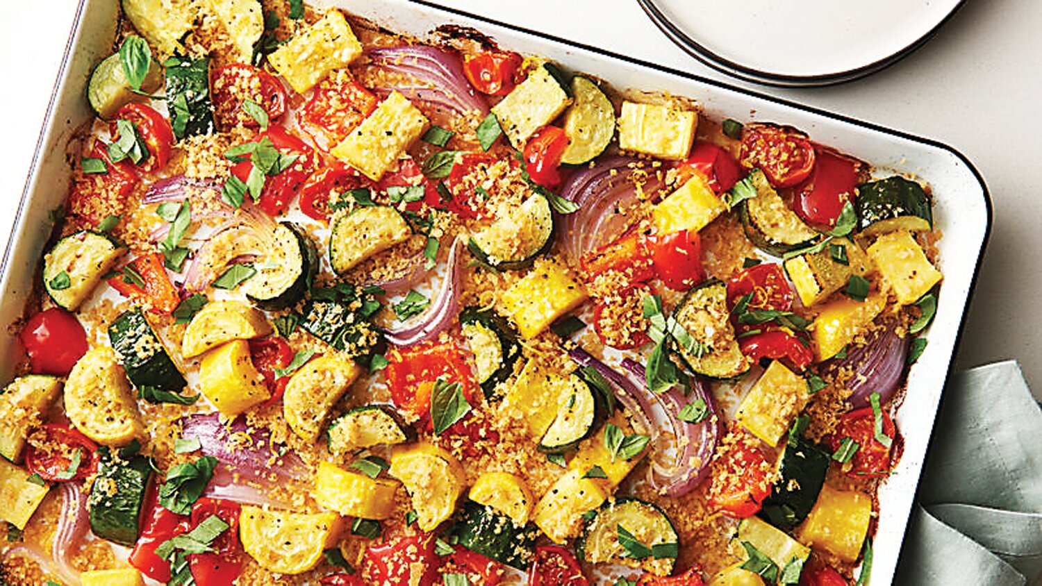 One idea for how to prepare the bounty of summer vegetables now in season is roasting them in a sheet pan like this one.