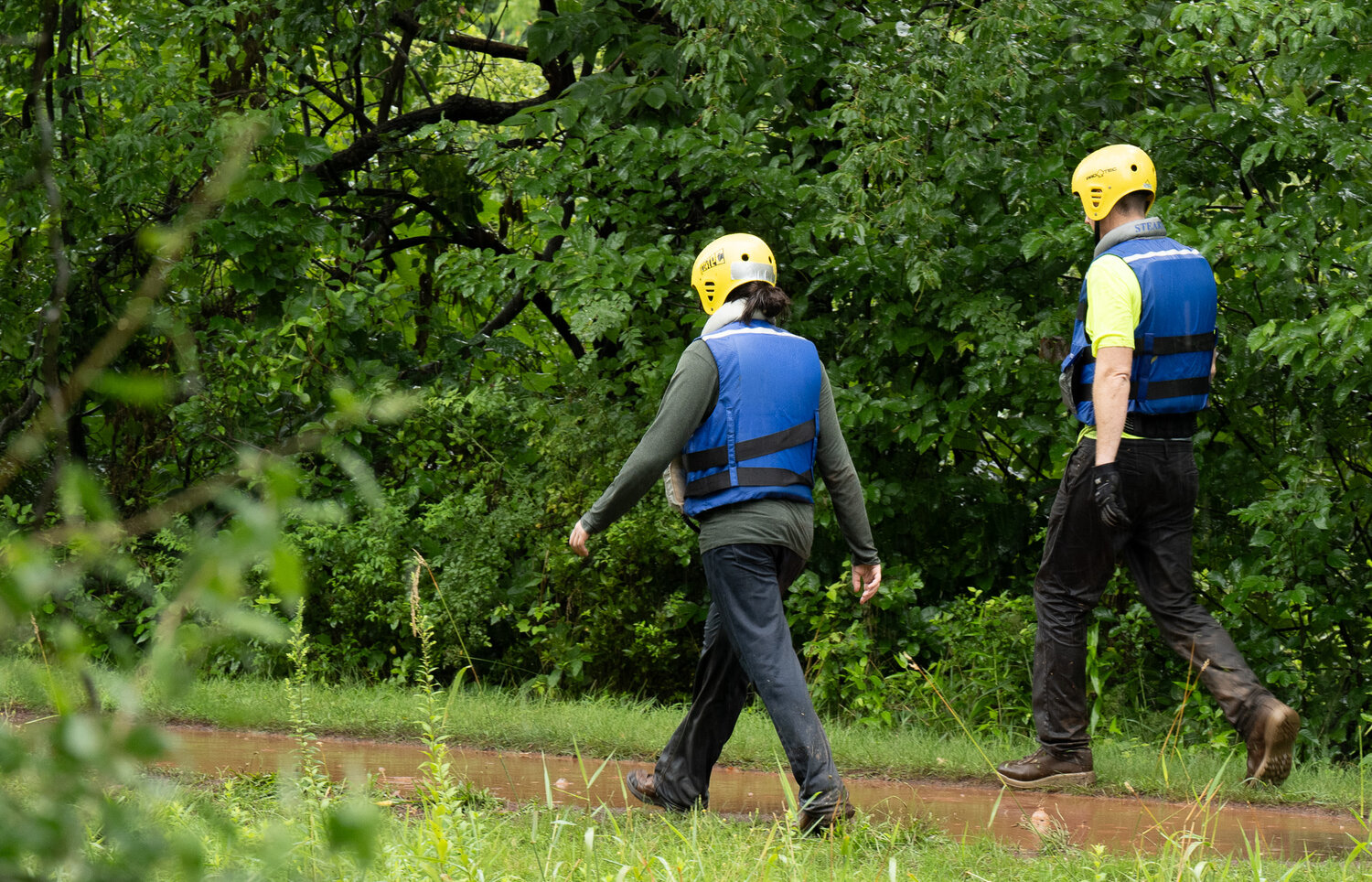 A rescue crew walks along the Delaware Canal towpath Sunday as the search for victims of Saturday’s flash flood continued.