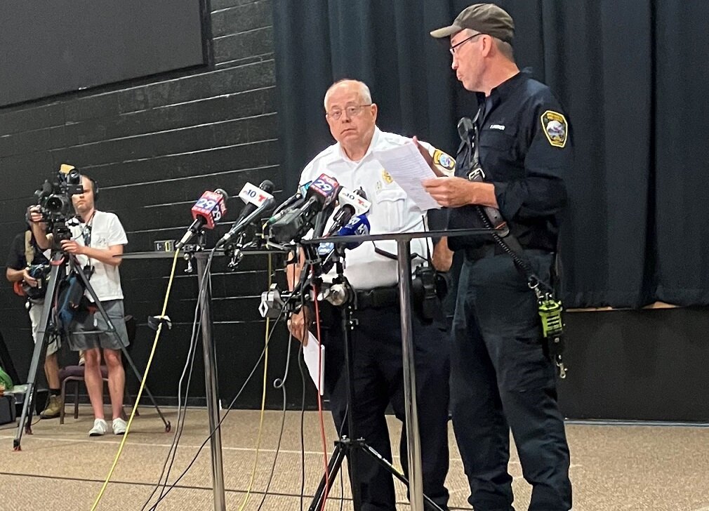 Upper Makefield Police Chief Mark F. Schmidt, left, and fire Chief Tim Brewer address the media gathered at Washington Crossing United Methodist Church Monday afternoon.