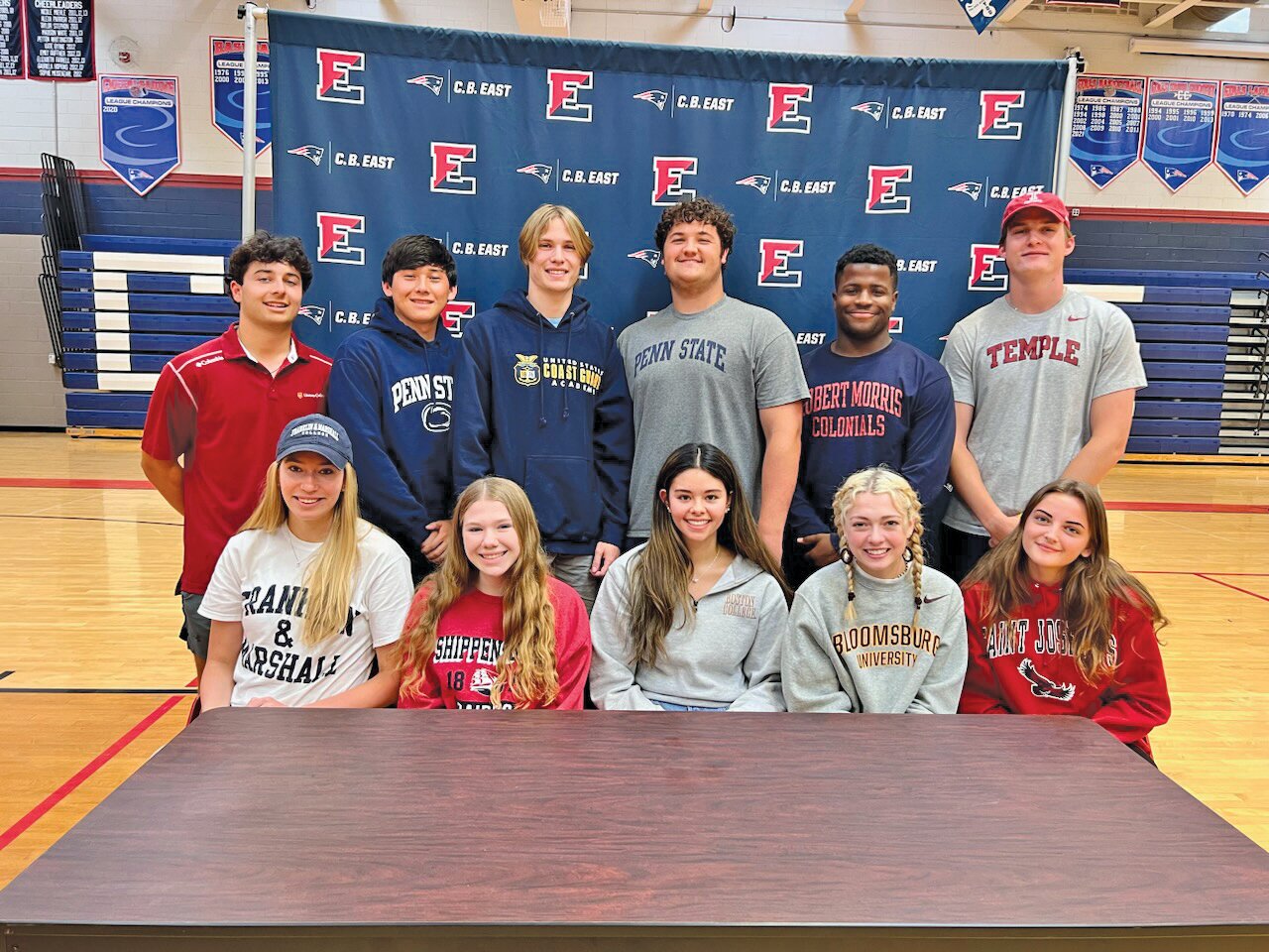 Central Bucks East seniors were recognized last month for their commitment to compete at the collegiate level. From left are: front row, Erin Suter, Carly Byrne, Alisa Cufone, Amelia Alfiero, Alessandra Schuster; back row, Luke Christmas, Dylan Walker, Matthew LaBouliere, Liam Powers, Ethan Shine and Patrick Keller.