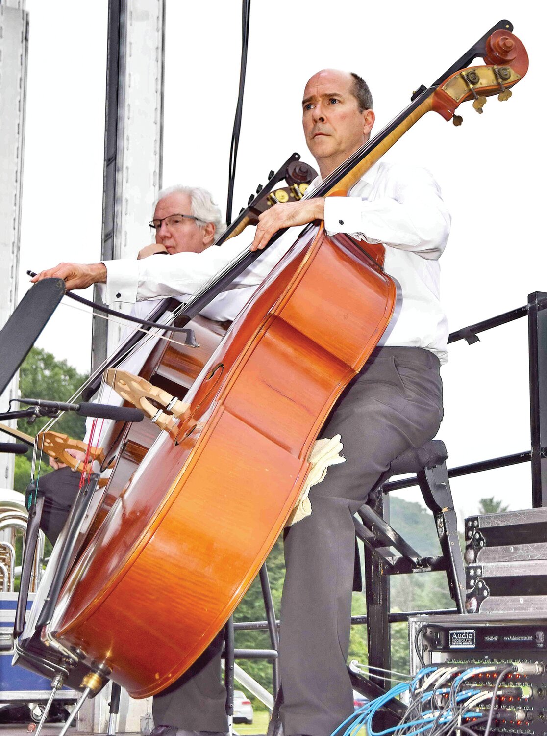 A member of the orchestra plays a double bass.