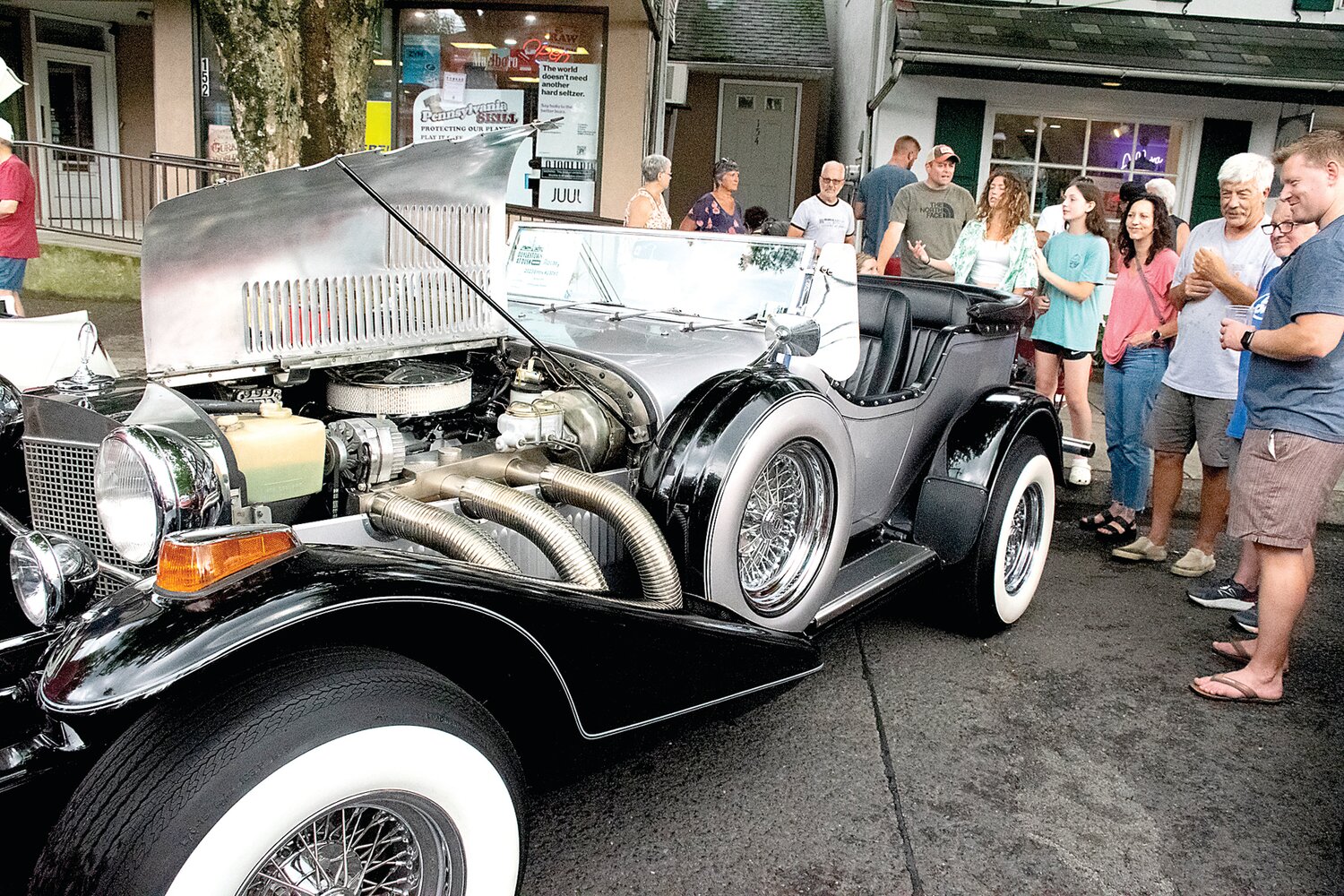 Richard Witt and his 1979 Excalibur Phaeton capture an audience after the rain.