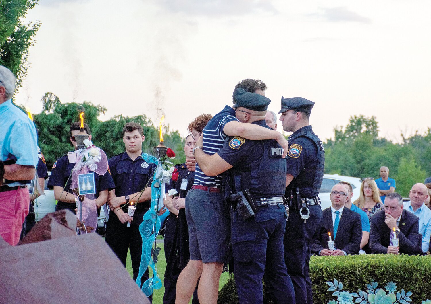 An attendee at the vigil embraces a first responder.