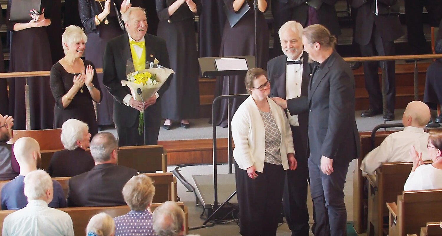 Emily Fulmer and John Conahan taking bows as Assistant Conductor Susan Johnson, singer Christopher Whitney, and Artistic Director Thomas Lloyd look on.