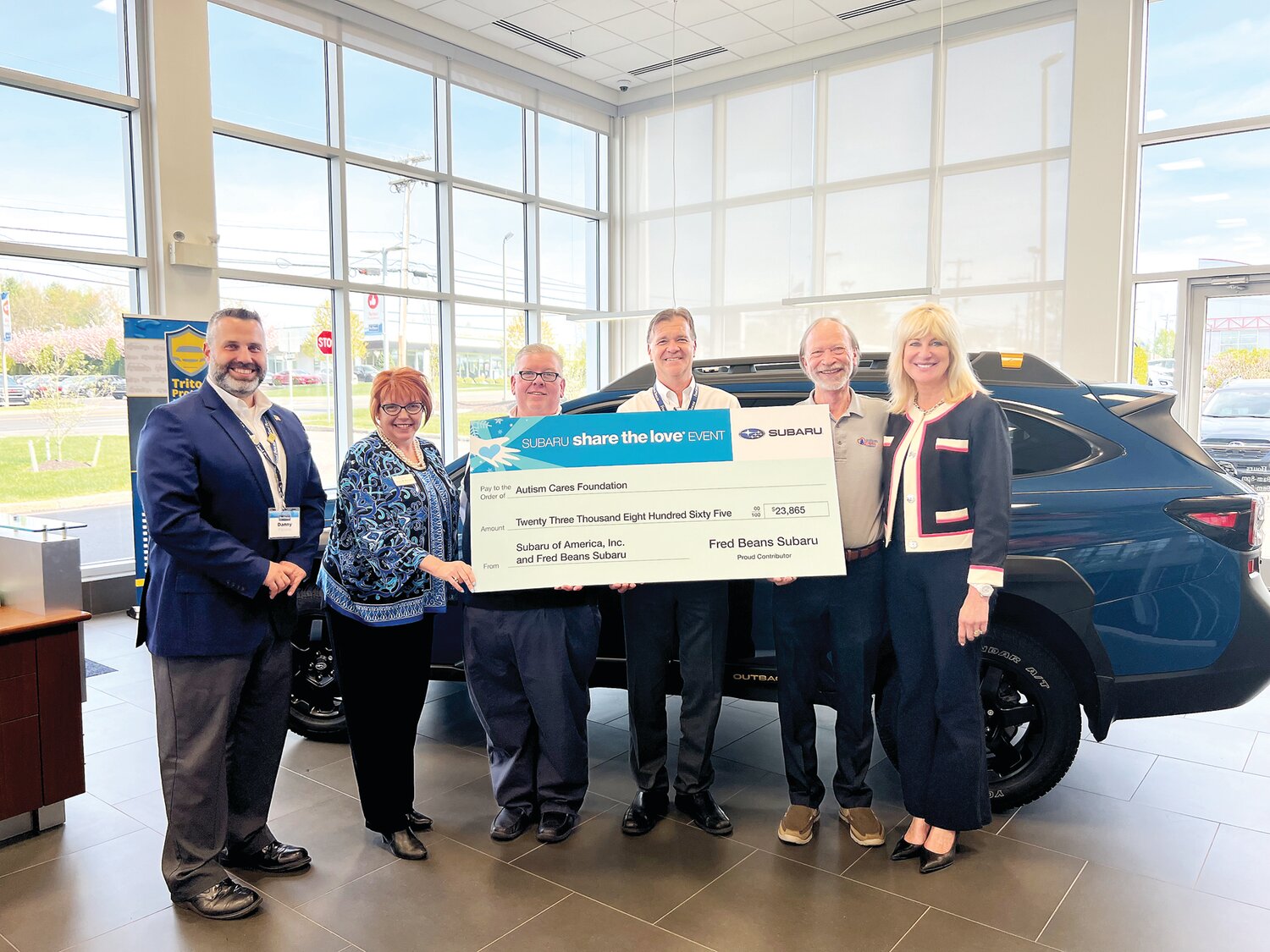 Fred Beans Subaru of Doylestown recently presented a donation to the Autism Cares Foundation based in Southampton following another successful year participating in the Subaru Share the Love Event. Among those presenting the check are Fred Beans Subaru General Manager Daniel Pavone, far left; General Sales Manager Todd Mock, center, holding check; and Fred Beans Automotive Group Vice President Beth Beans Gilbert, far right.