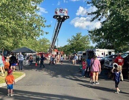 A Doylestown Fire Company truck’s ladder reaches for the sky during Tuesday’s National Night Out event at Central Park.