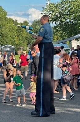 Professional stilt walker Keith Crabbs of “we bring the fun365” entertains during National Night Out in Doylestown Township. He was
authorized to wear the uniform of a Doylestown Township police officer for the event.