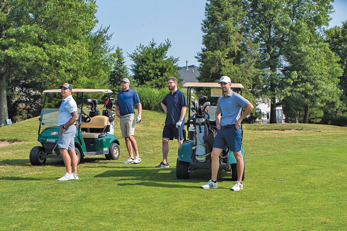 Mike Christou, owner of Ardana Food and Drink, right, and his fellow golfers on the links.