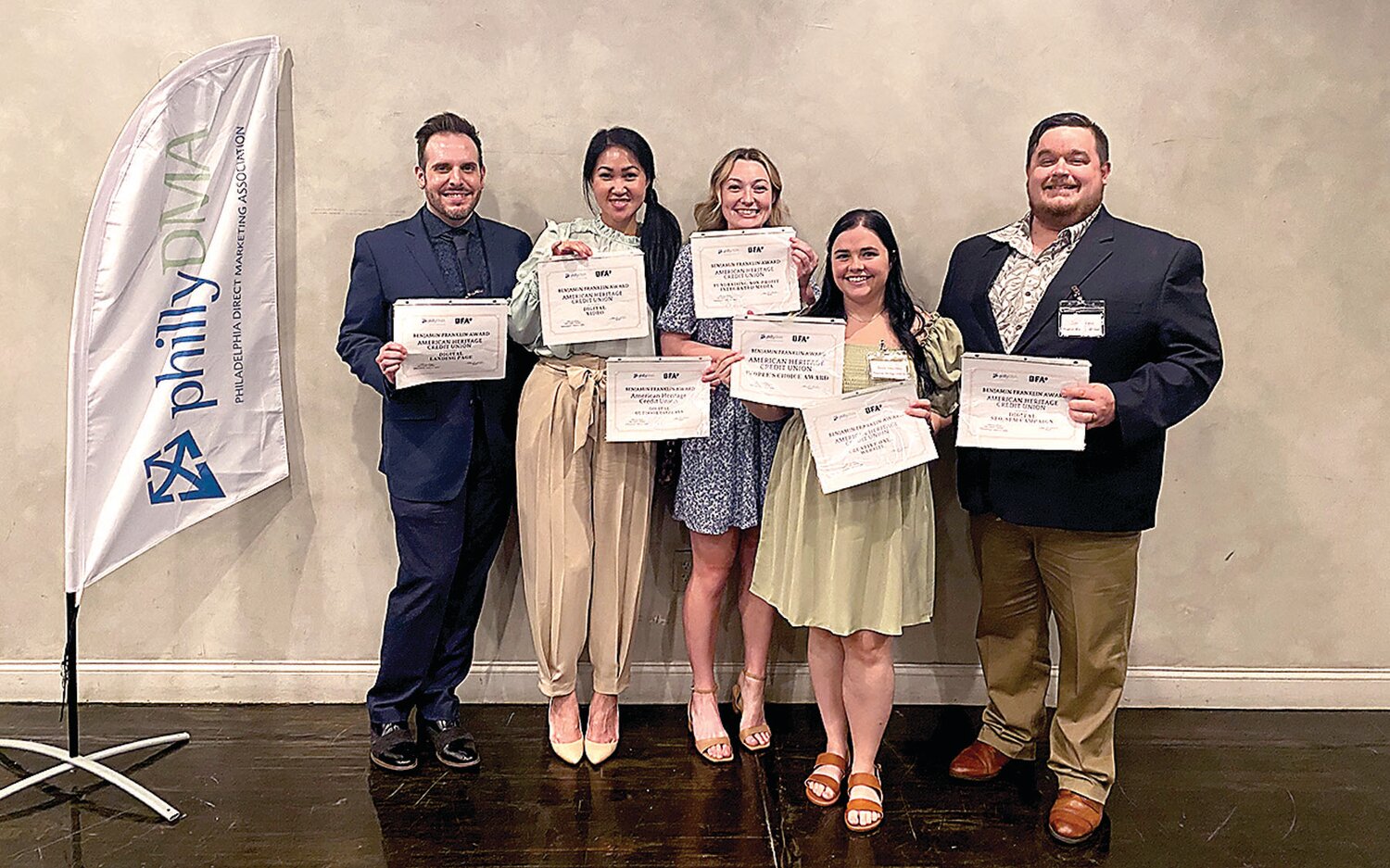 American Heritage’s Marketing Team members display seven Benny Awards for marketing, community outreach, and business development excellence.