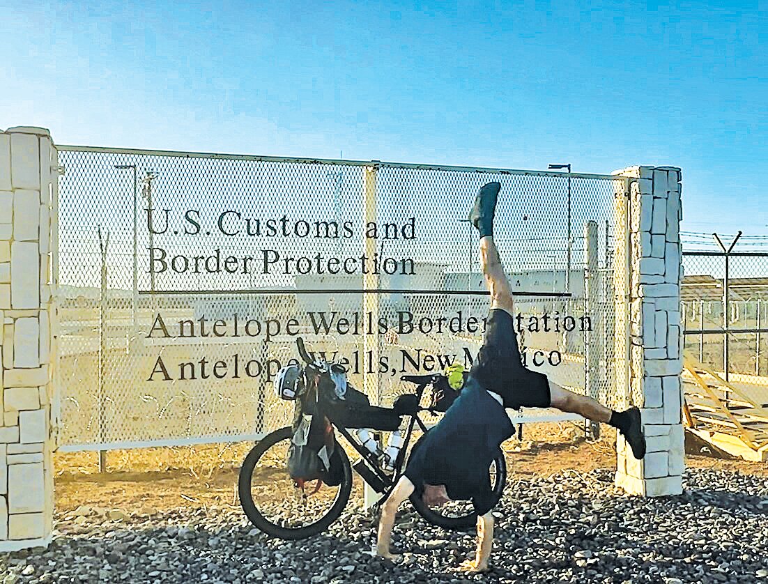 Mark Gibson does a cartwheel after finishing a 2,745 bike ride from Canada to the U.S.-Mexico border.