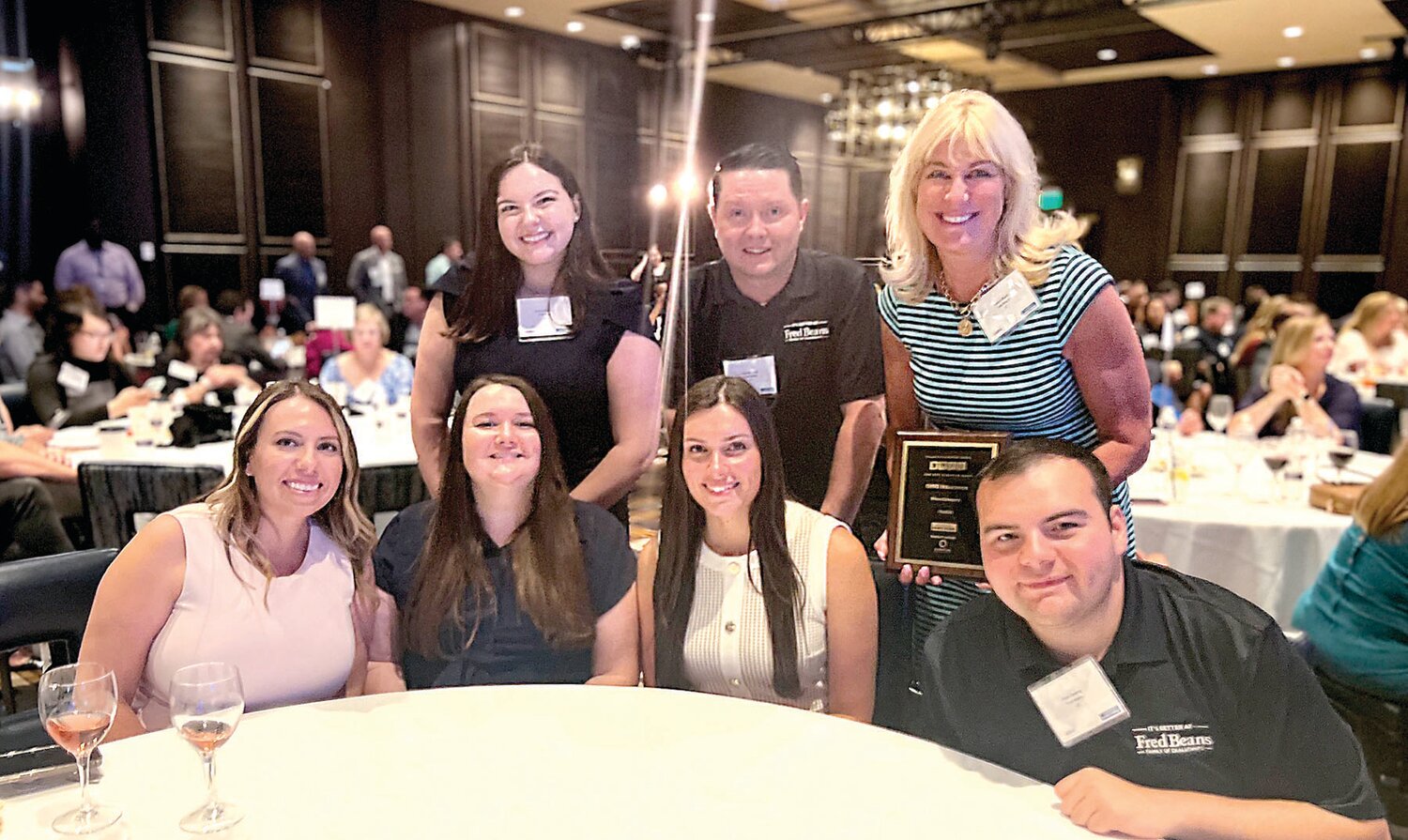 Top right, with members of the human resources team, is Fred Beans Automotive Group Vice President Beth Beans Gilbert, who holds the fifth straight Best Places to Work award earned by the automotive company.
