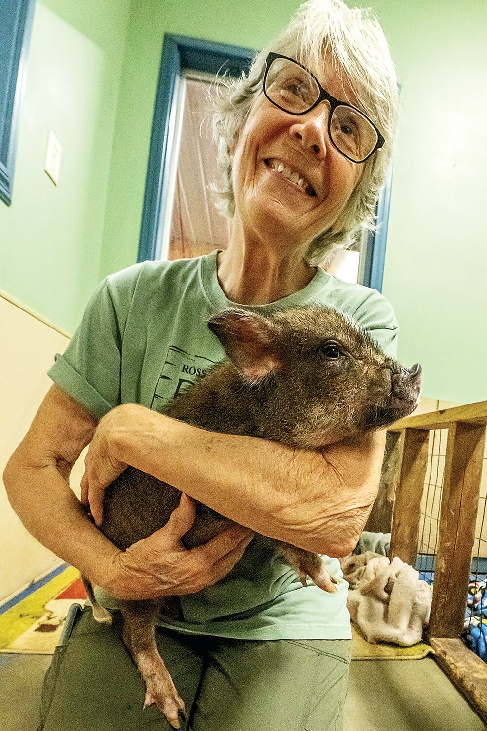 Susan Magidson, founder and owner of Ross Mill Farm, holds a piglet named Jack, who was rescued with his sister from a home. Both pigs suffered from neglect. Jack’s sister died.