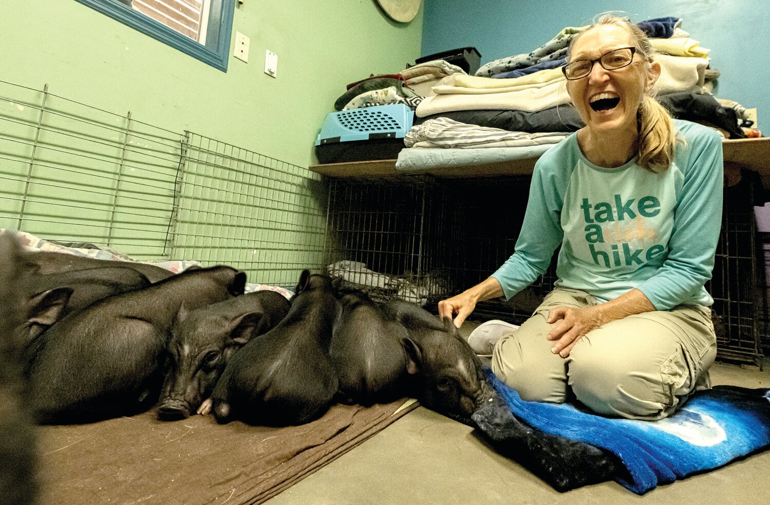 Sheryl Slopey cares for a group of piglets rescued from a home, where the owner’s intention was to feed them to a pet snake. Today, they wait for adoption and a “forever” home.