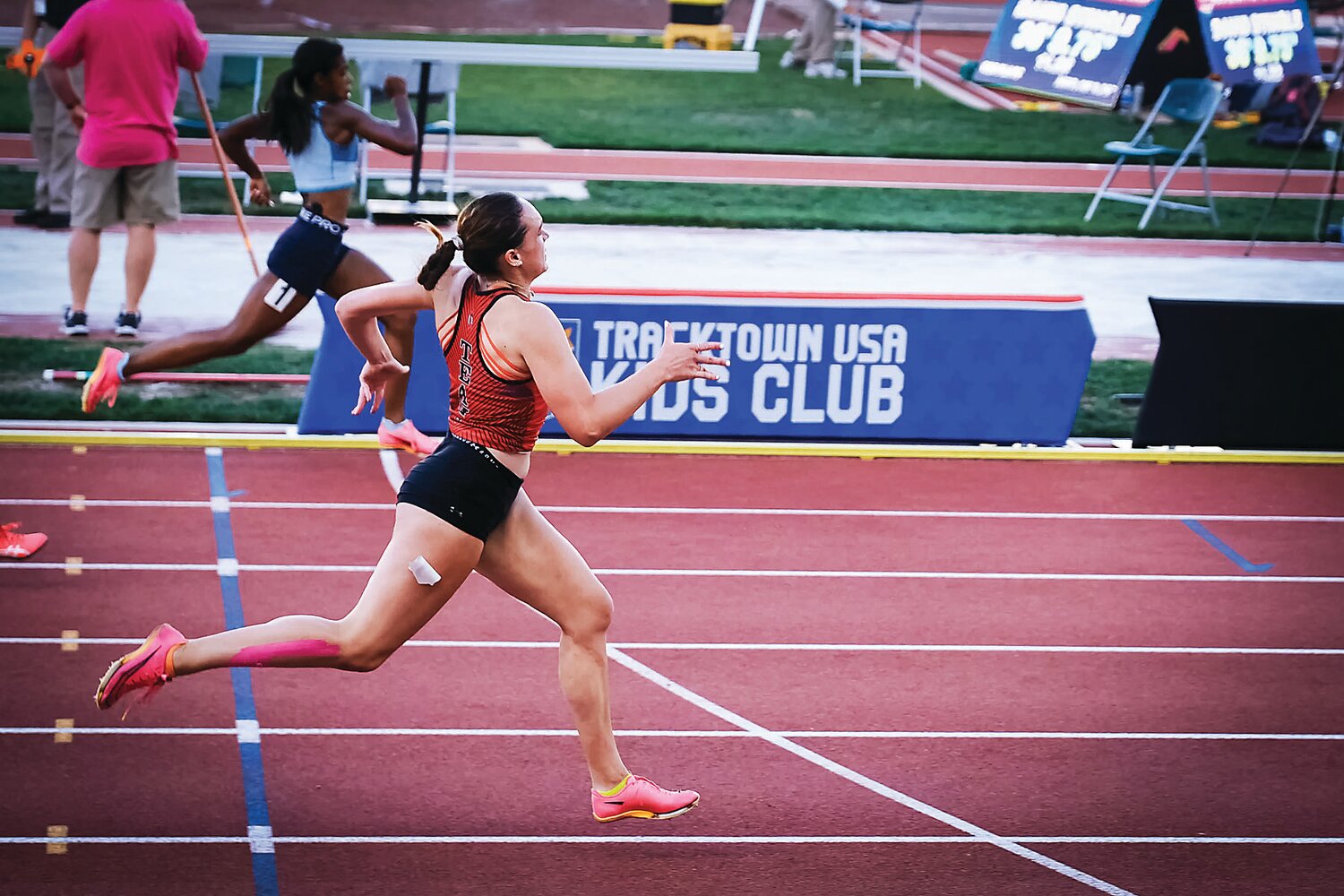 Fiona McKenna out leans her competition to finish  third overall in the 200-meter run at the USA Track & Field (USATF) Junior Olympic National Championships.