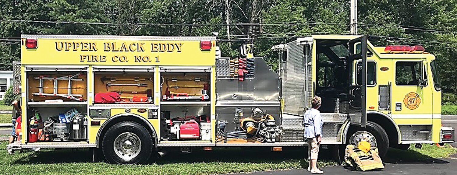 A community member views an Upper Black Eddy Fire Company No. 1 firetruck on display at the Bridgeton Township UBE Community Resource Day Aug. 12.