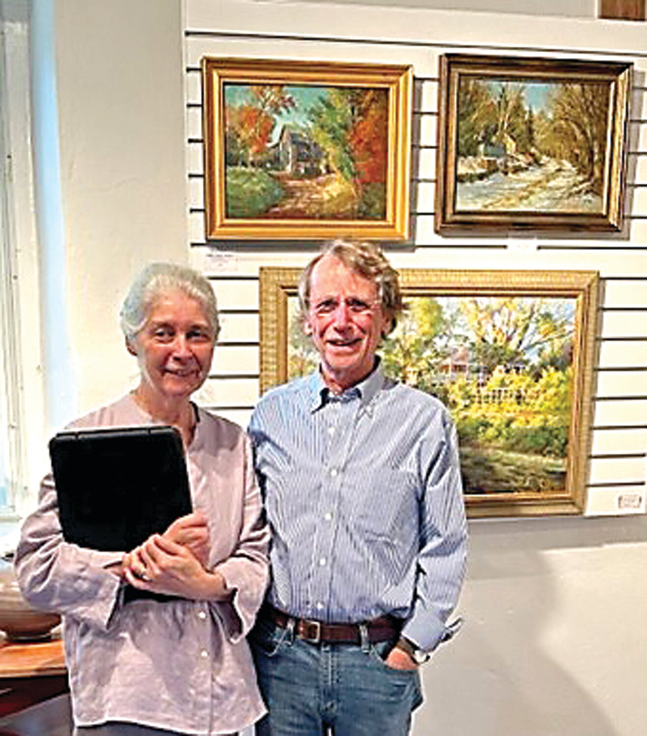 Artist Dot Bunn with Larry LaFevre and his new painting, “Bucks County Autumn.”