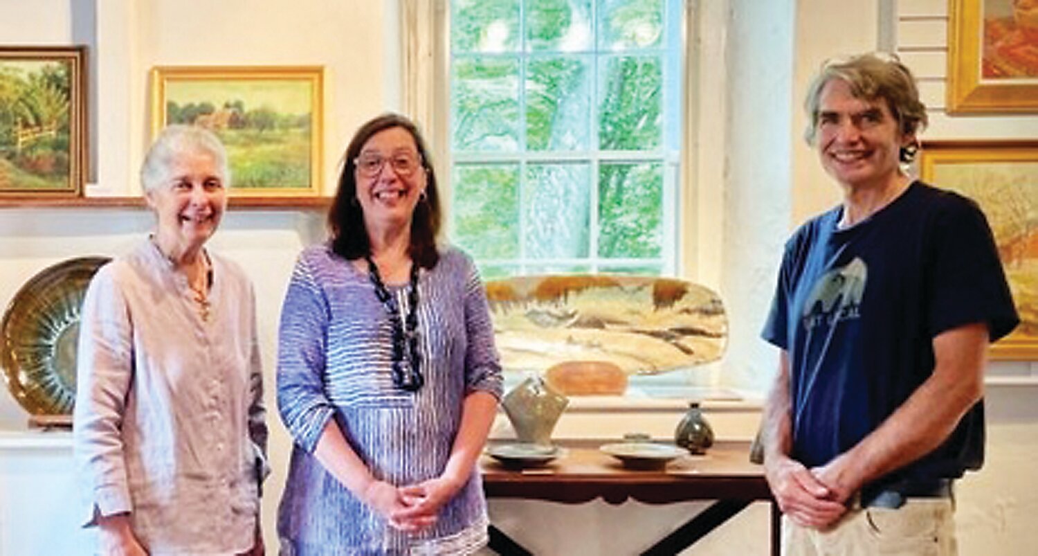 Dot Bunn, left,; Lisa A. Hanson, art consultant; and Willi Singleton with his pottery.
