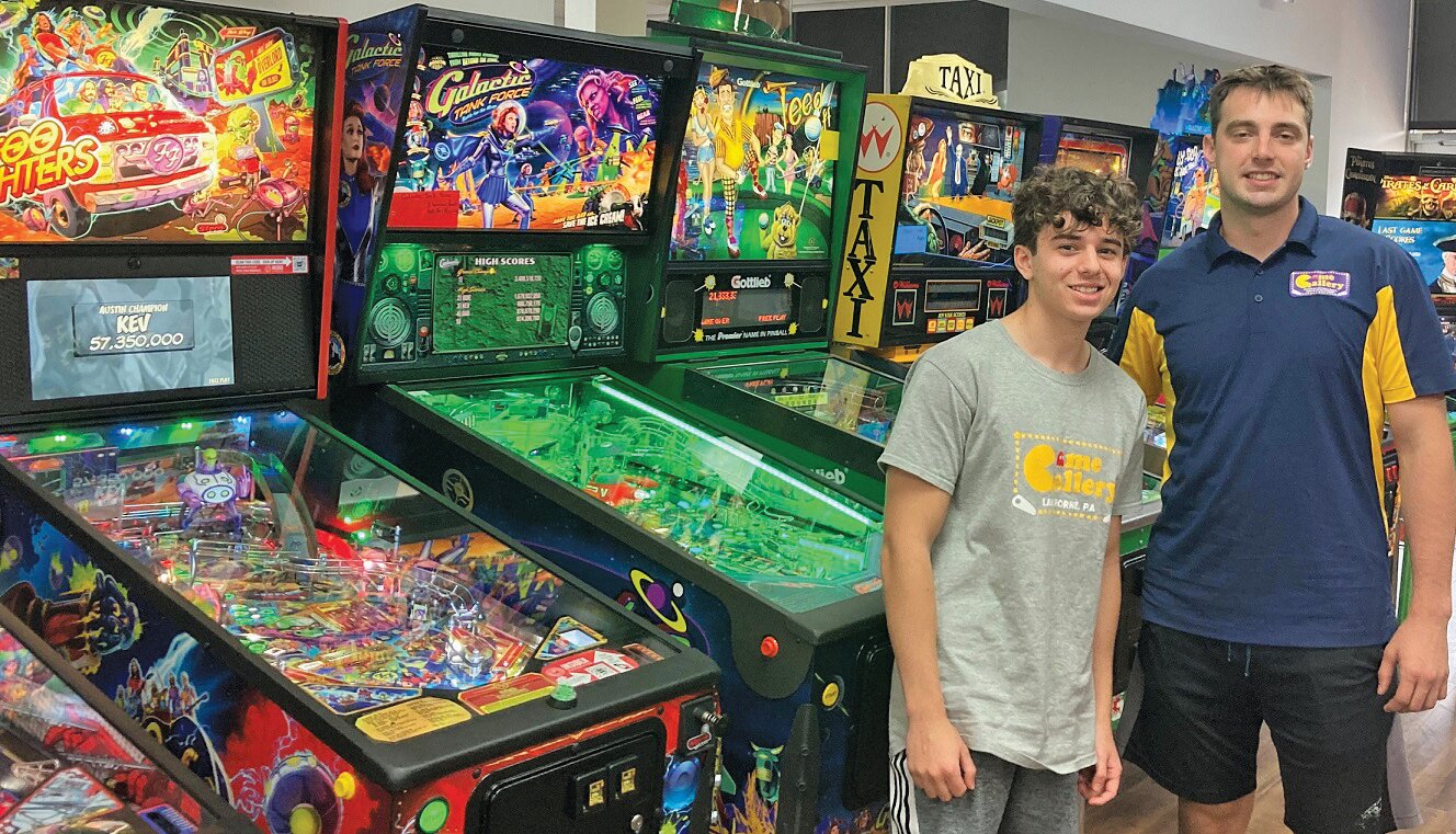 Co-owner Mike Smith, right, and employee Colin Metsikas next to the pinball machines at Game Gallery in Langhorne Borough.