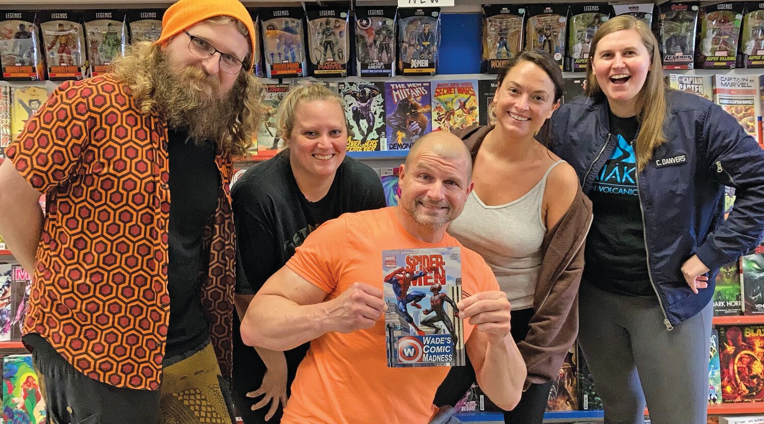 The staff at Wade’s Comic Books of Levittown poses for a photo at its shop.