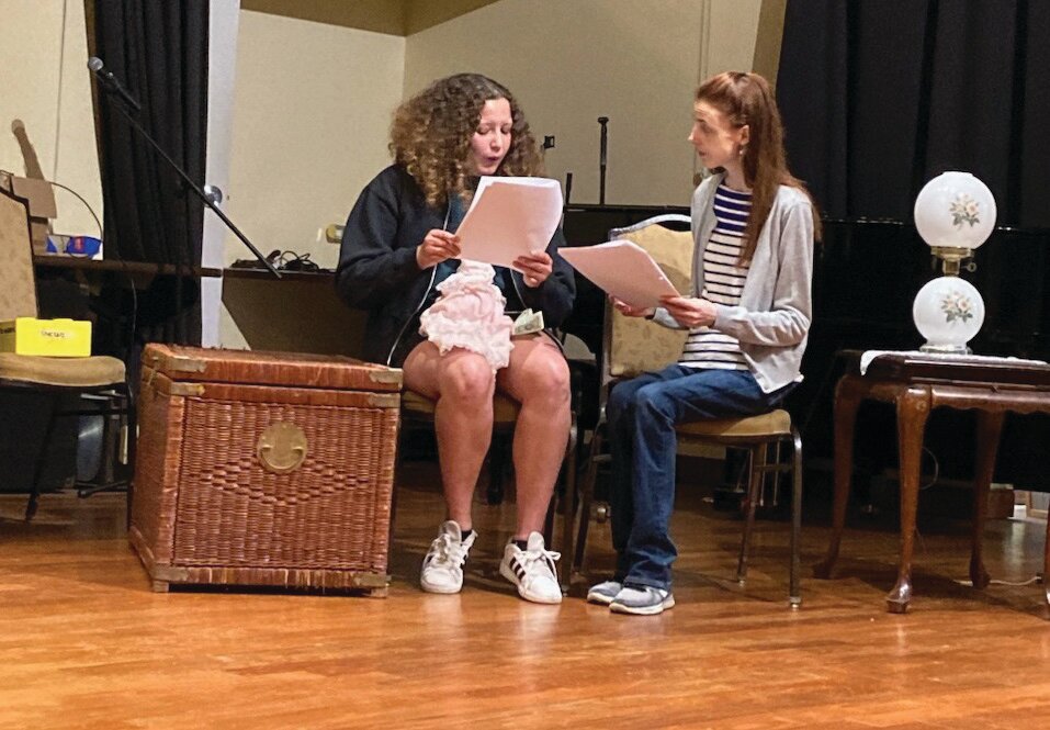 Lucy Spiegel, left, (Hanna) and Caity Brown (Irena Sendler) run lines while rehearsing Tim Caso’s play “I Kiss Your Hands: A Story of Hope, Rescue and Deliverance,” which debuts Sept. 8 at Chandler Hall in Newtown Township.
